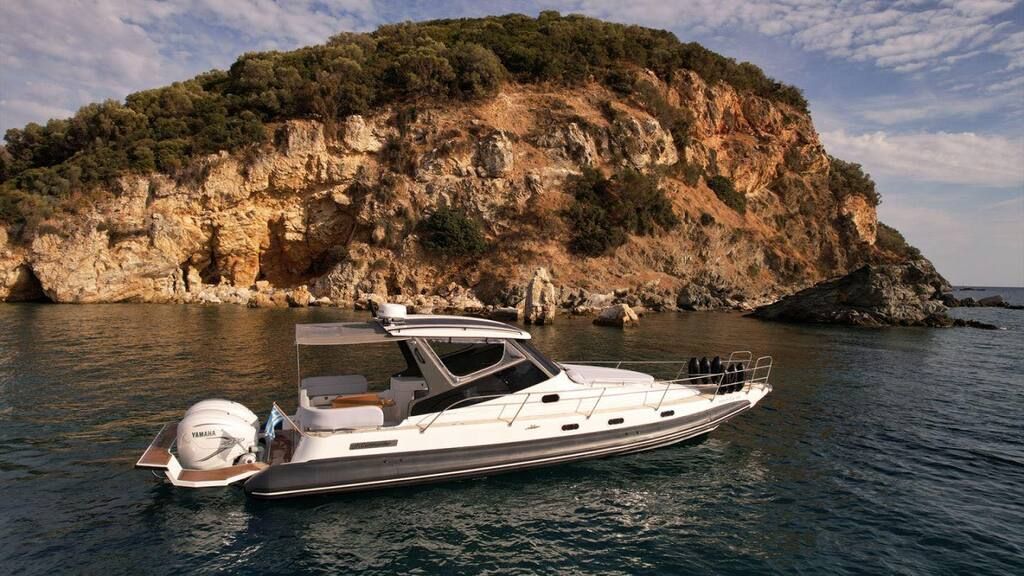 Custom 40 anchored in front of a rocky headland